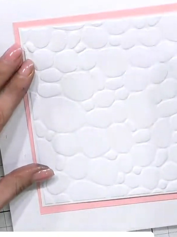 Step 1: Place your white cardstock into the Pebble Dash embossing folder. Position the card centrally within the folde