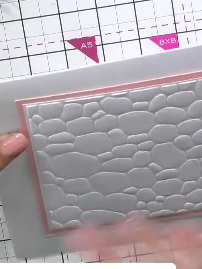 Step 2: Place your white cardstock with the embossing folder into the magnetic glass mat. Run the cardstock through yo