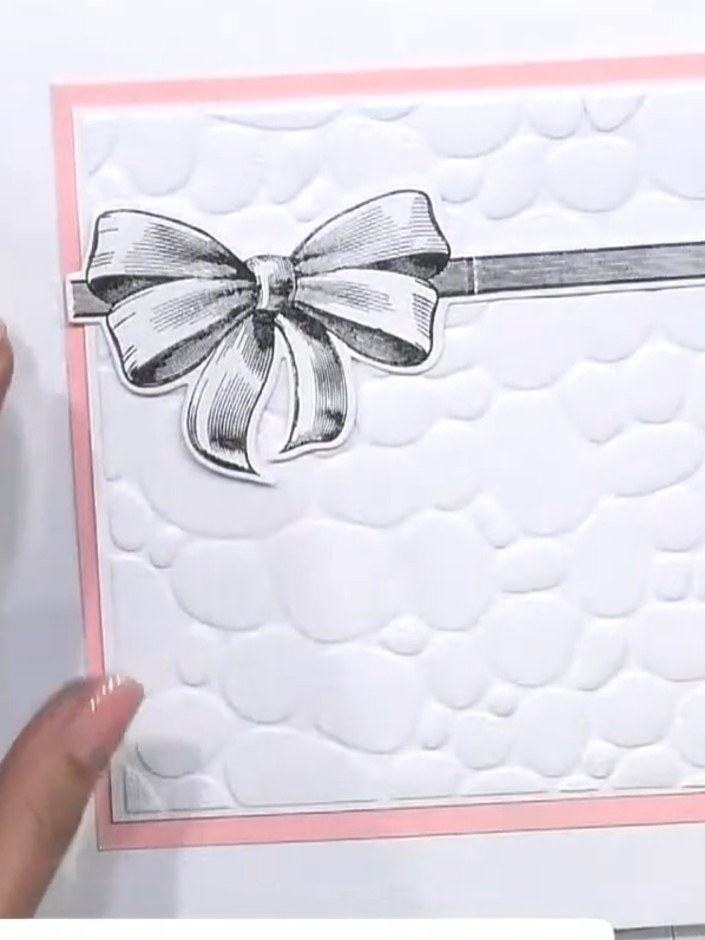 Step 3: Remove the embossed card from the embossing folder. Layer the white embossed panel onto a pink card base, posi