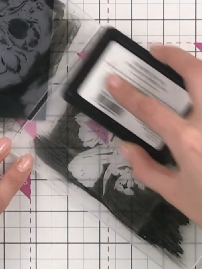 Step 10: Blot the excess watercolour with tissue paper to create texture and reveal the underlying black embossed detai