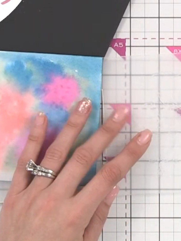 Step 8: Activate confetti ink on a scrap piece of card. Using a nearly-dry brush, dry brush the ink onto the embossed 