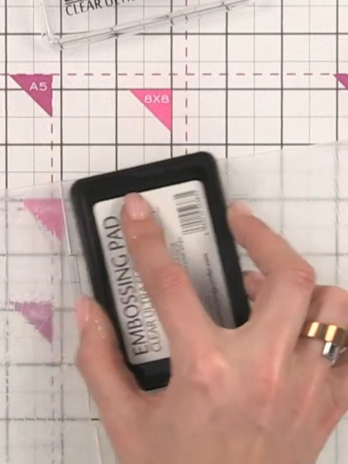 Step 6: Remove the card from the embossing folder and immediately pour embossing powder over the sticky ink, ensuring 