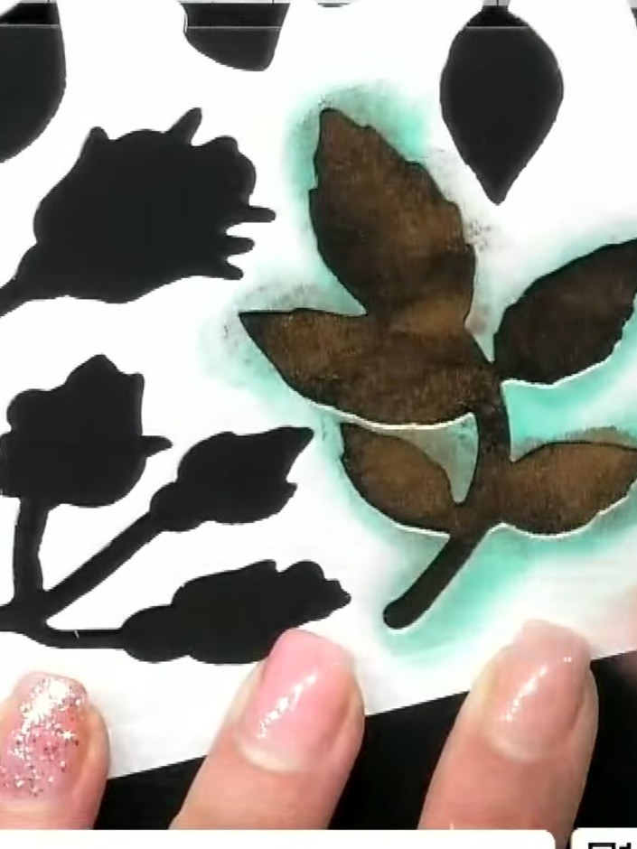 Step 5: Use a leaf stencil with a metallic ink pad to add a decorative pattern across the black card background, creat