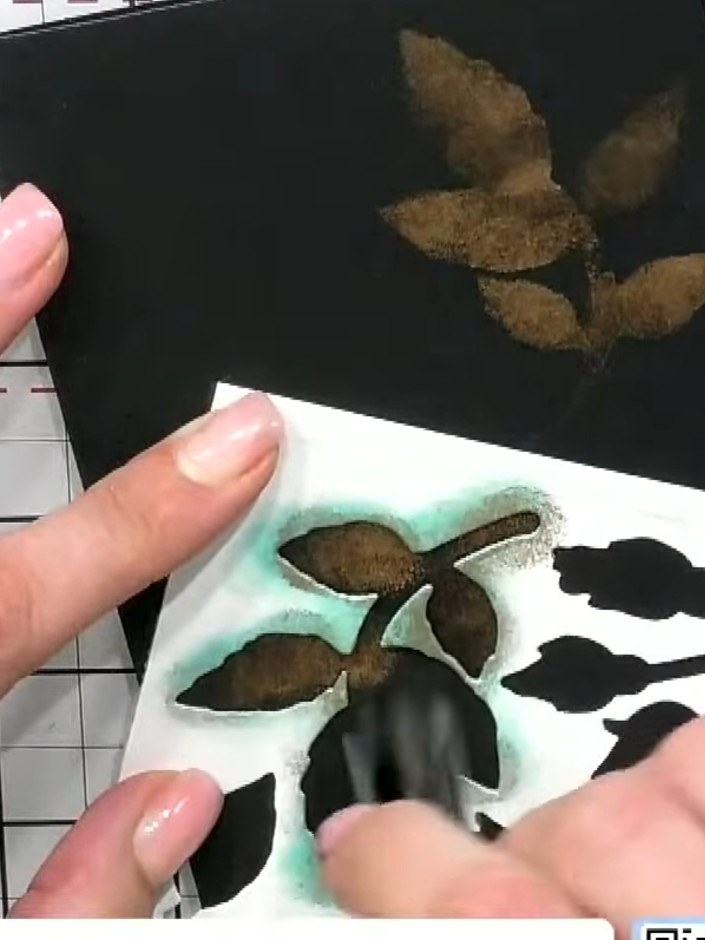 Step 6: Layer the pre-coloured die-cut flower embellishments on top of the stencilled background using foam tape to ad