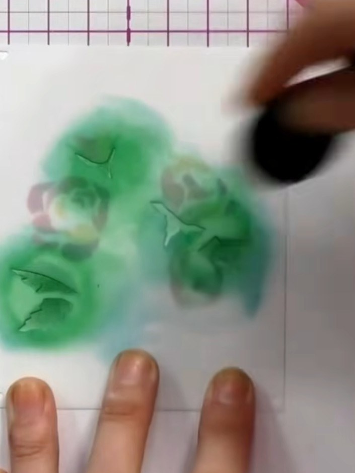 Step 4: Apply stencil five to add detail to the flower petals, using a dauber or sponge to apply green ink. Then apply