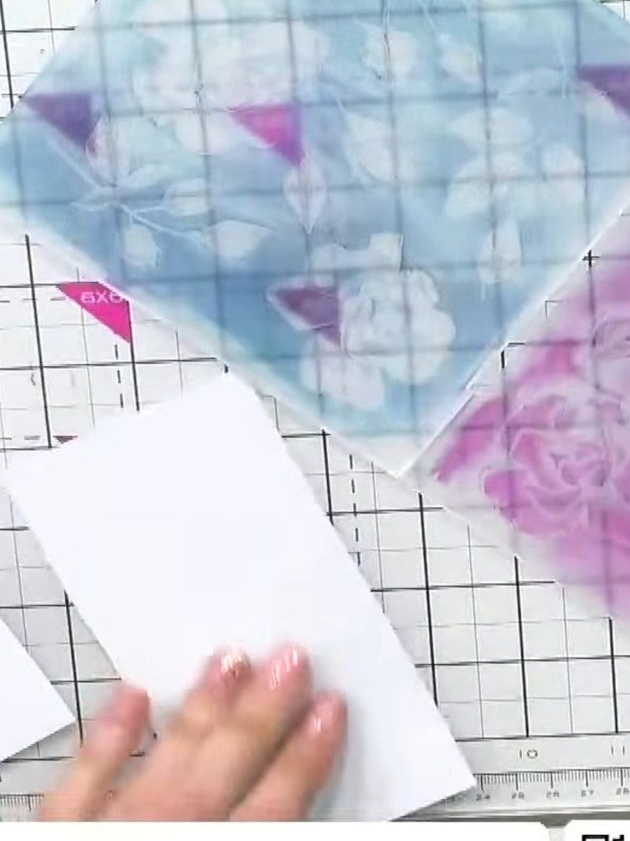 Step 5: Insert a piece of white card stock into the inked embossing folder, positioning it between the two halves of t