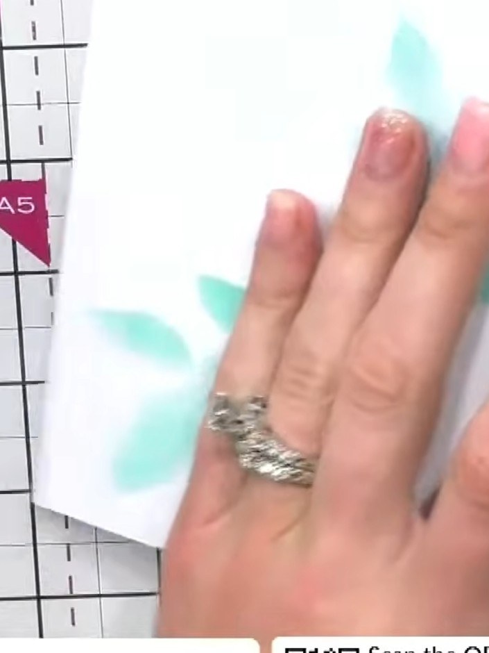 Step 1: Use a leaf stencil and metallic ink to create a background pattern on your white card base. Apply the ink thro