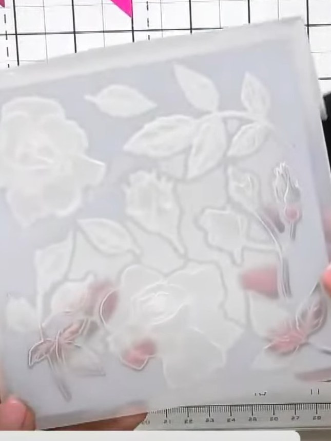 Step 4: Remove the embossed cardstock from the folder to reveal the individual hibiscus flower and leaf embellishments