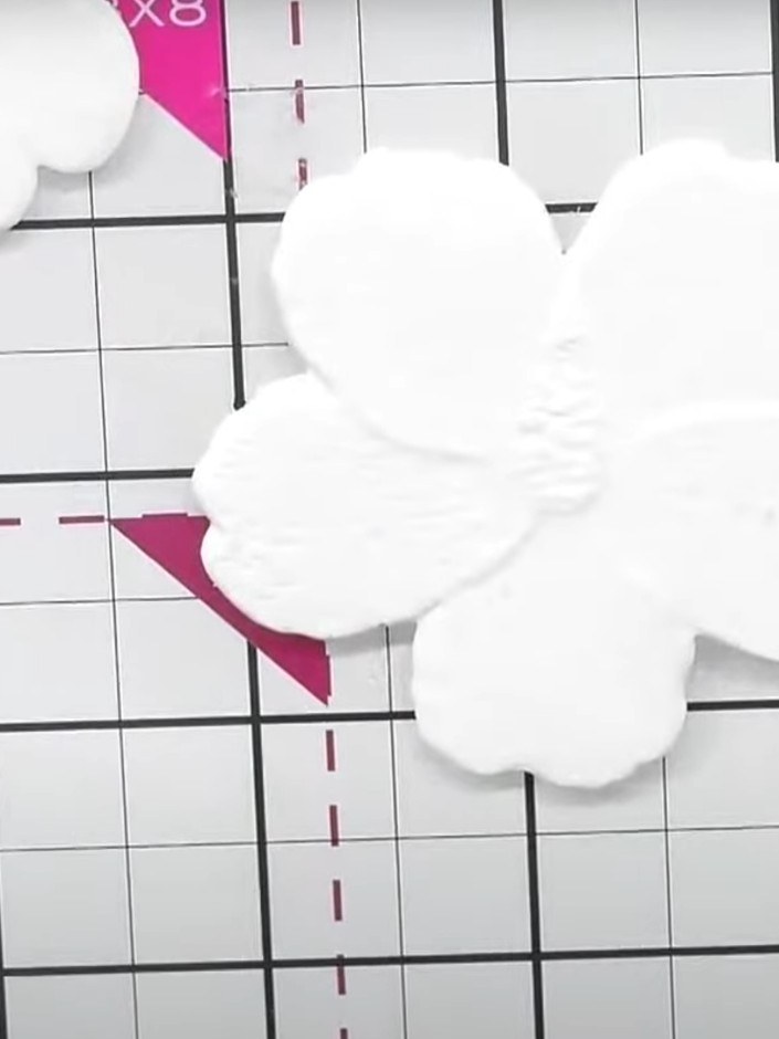 Step 1: Cut out a single hibiscus embellishment from white cardstock using the Dainty Hibiscus embossing folder and di