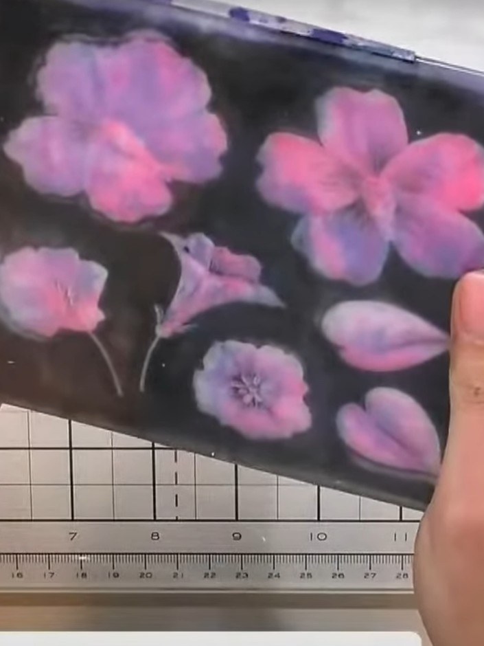 Step 1: Apply pink ink from the ink pad directly onto white cardstock in a dabbing motion, creating scattered flower-l