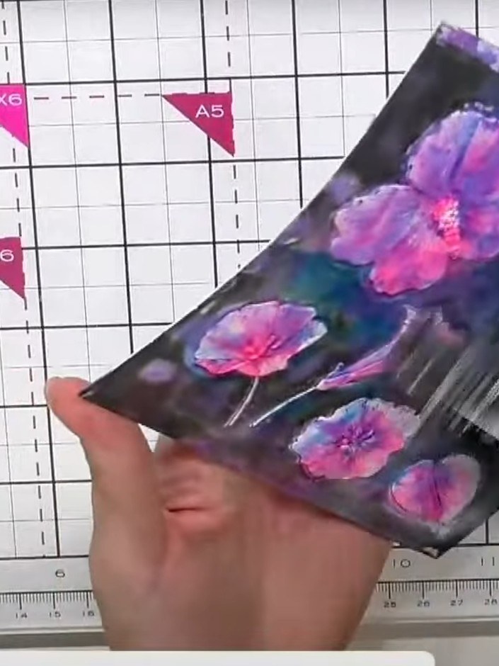 Step 4: Place the painted cardstock into the Dainty Hibiscus embossing folder with the die plate in position, ensuring