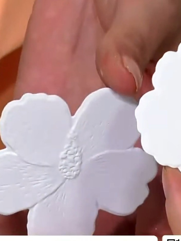 Step 5: Arrange the die-cut flower elements on your card base to create your desired composition. You can build corner