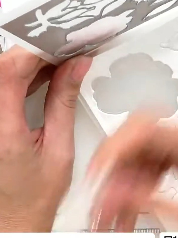 Step 4: Pick up watercolour ink on a brush and apply it directly to the embossed flower shapes. Allow the ink to settl