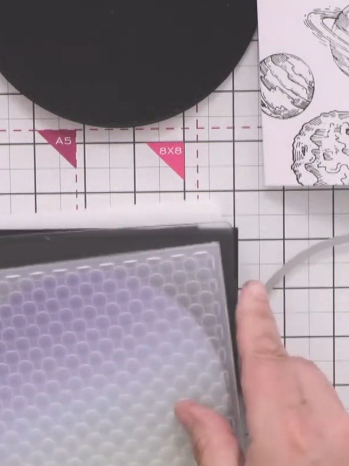 Step 3: Run the smaller patterned circle through an embossing folder with a retro spots design to add texture and brea
