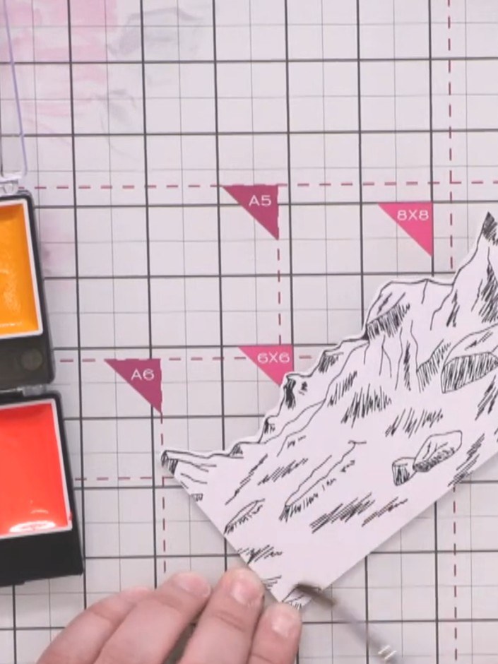 Step 5: Wet the landscape piece with water. Apply vibrant watercolour brush colours, starting with pink at the top, bl