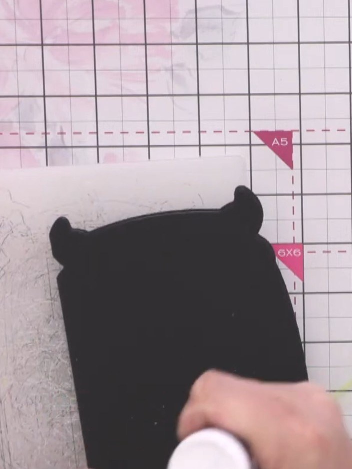 Step 4: Apply adhesive tape along the edges of the black monster body pieces to secure them together, forming the comp