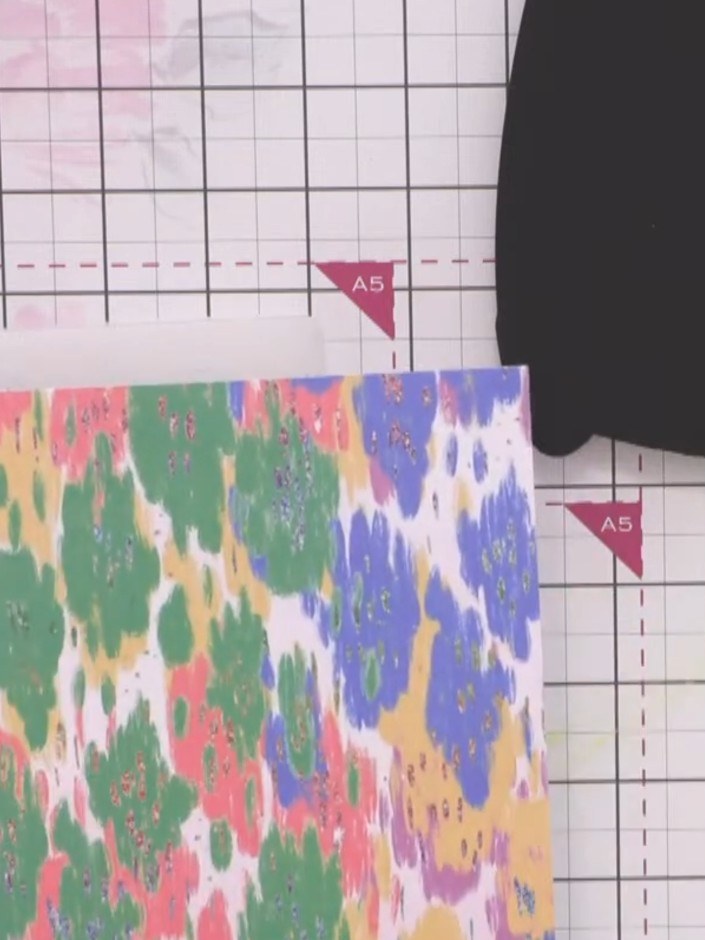 Step 5: Die cut the monster body from the multicoloured splodgy patterned paper. Adhere the die-cut body onto the blac
