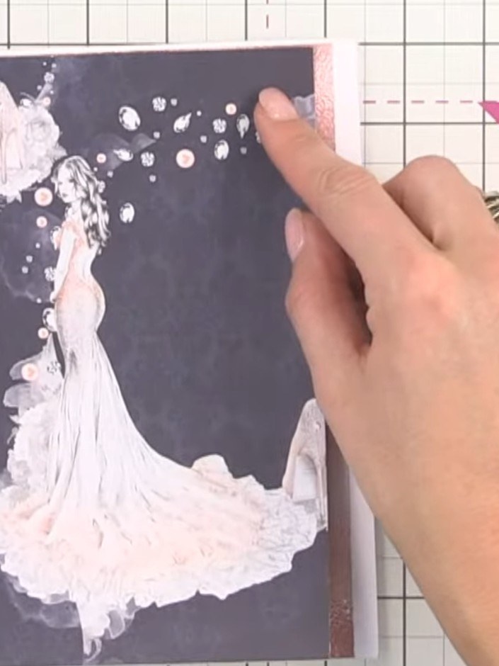 Step 2: Cut out the patterned lady illustration from the paper. Position it on the card front, placing it to one side 