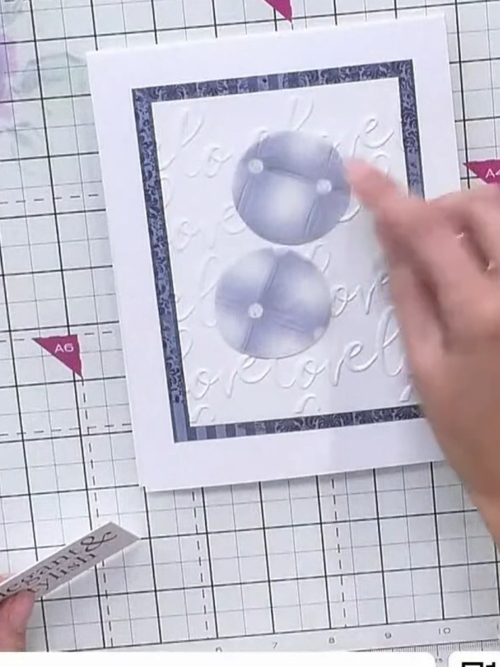 Step 7: Position the embossed white cardstock panel onto the card base, layering it to showcase the embossed texture. 