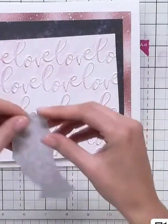 Step 4: Position the navy patterned paper with 'love' text onto the black card layer as a secondary decorative element