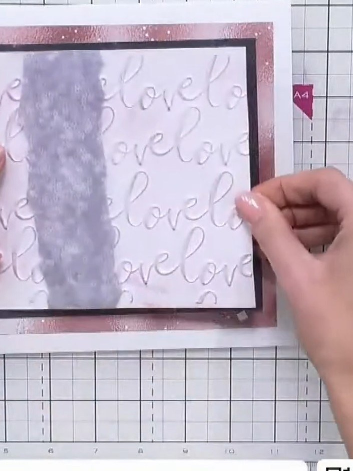 Step 5: Place the embossed white panel onto the black matted layer. The embossed texture with the 'love' pattern shoul
