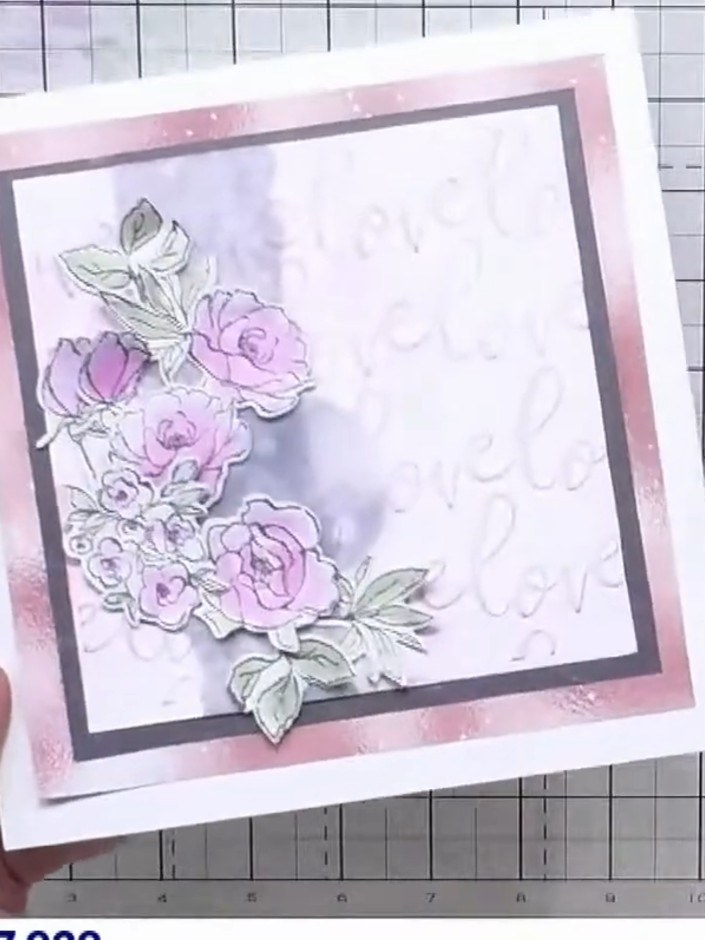 Step 7: Layer the painted floral elements onto your card base using foam pads to create dimension. Position the flower