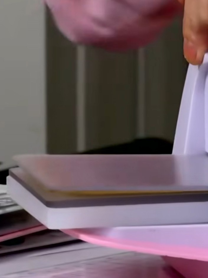 Step 2: Feed your card through the pink die-cutting machine with the wood texture embossing folder to cut and emboss t