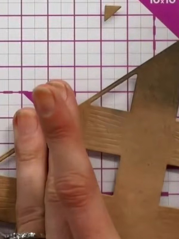 Step 3: Apply teal or brown ink selectively to the embossed areas using your finger. Dampen your finger with a little 