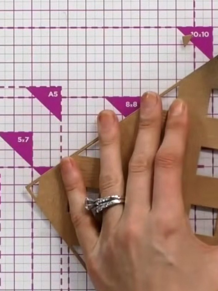 Step 5: Mount the embossed house die-cut onto your chosen card base. Position it centrally and secure with adhesive, e