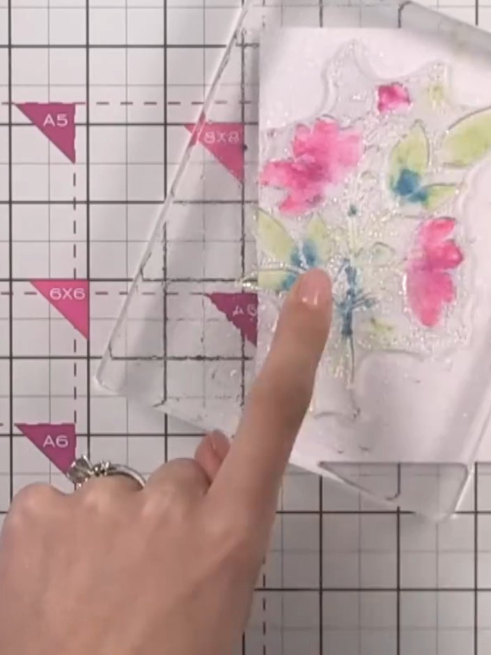 Step 6: Press the watercolour stamp firmly onto white cardstock. Lift the stamp away to reveal the watercolour floral 