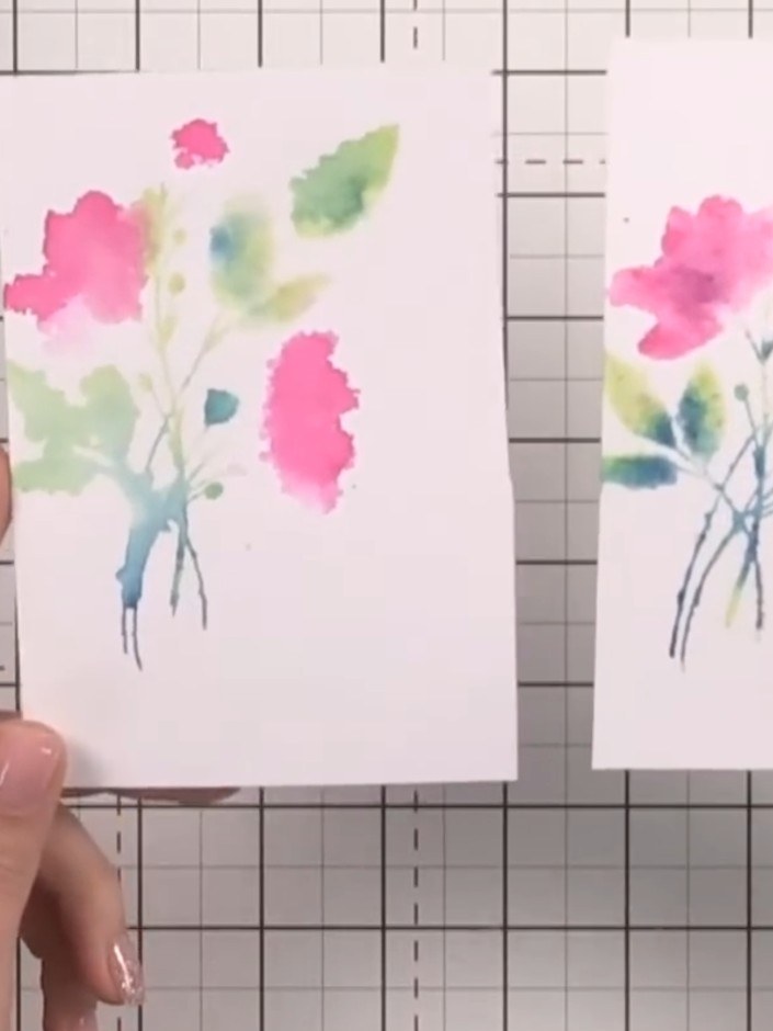 Step 8: Stamp the outline flower design over the watercoloured panel to add definition and detail. Position the stamp 