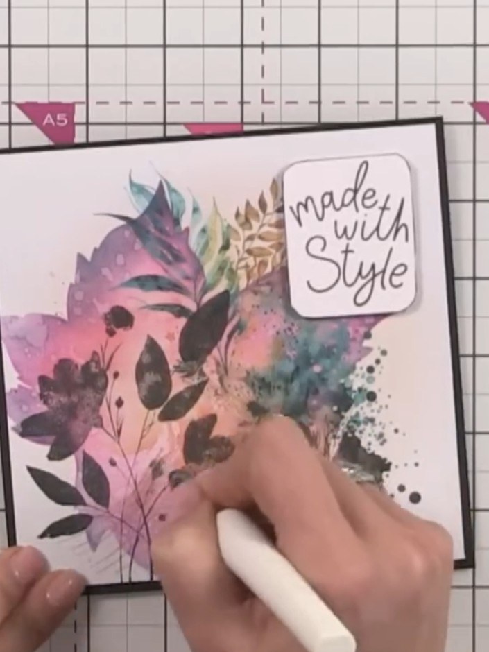 Step 11: Add purple sparkle pen accents to areas of the watercolour background to accentuate the design. Optionally add