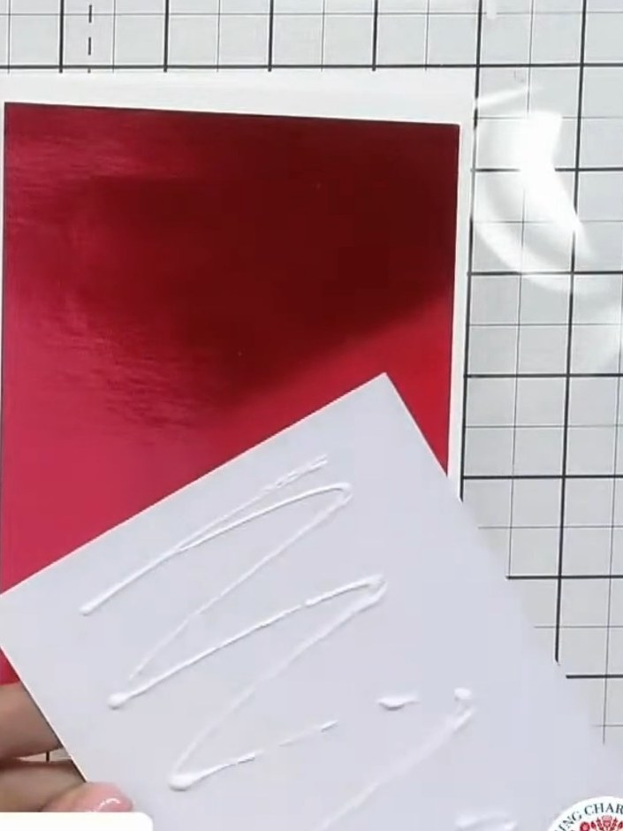 Step 2: Cut a piece of red metallic cardstock slightly smaller than your acetate piece. This will sit behind the flora