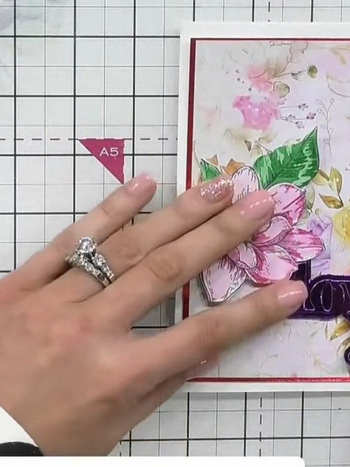 Step 6: Add two small leaves from your embellishment stash and tuck them under the purple sentiment piece for subtle i