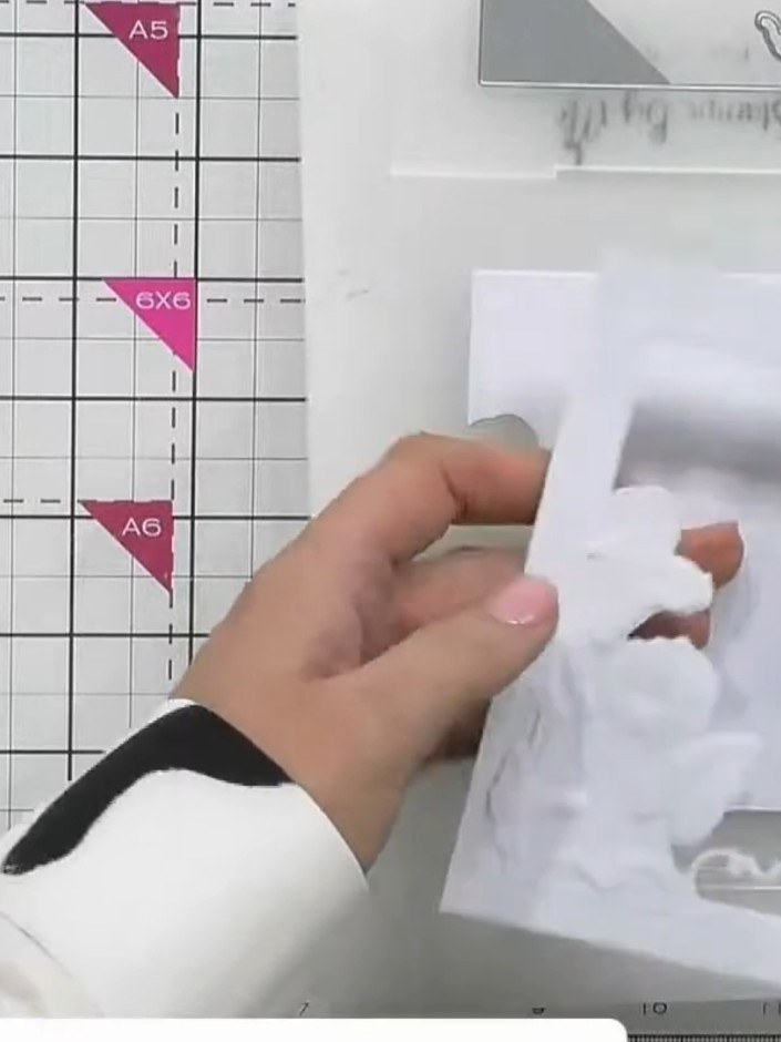 Step 2: Carefully pop out the die-cut design from the embossed white cardstock, removing all the cut pieces to reveal 