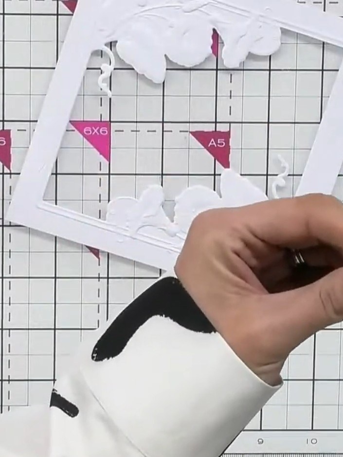 Step 4: Place foam pads on the back of the embossed aperture frame. Position the frame offset on your card base to cre